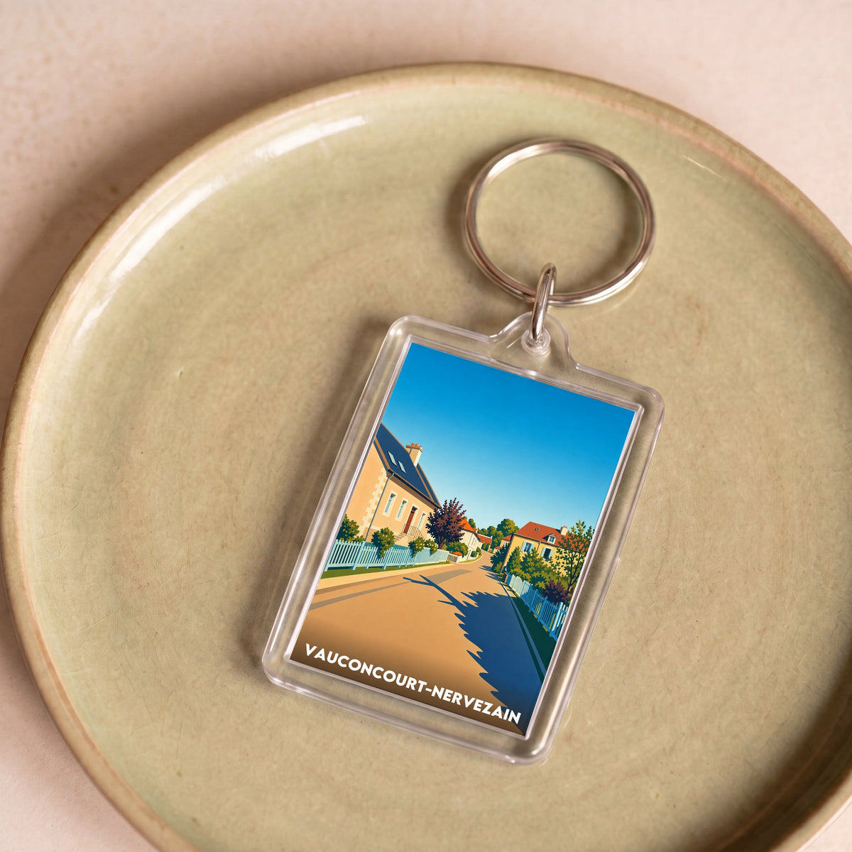 Porte-clés souvenir de la ville de Vauconcourt-Nervezain avec une illustration stylisée.