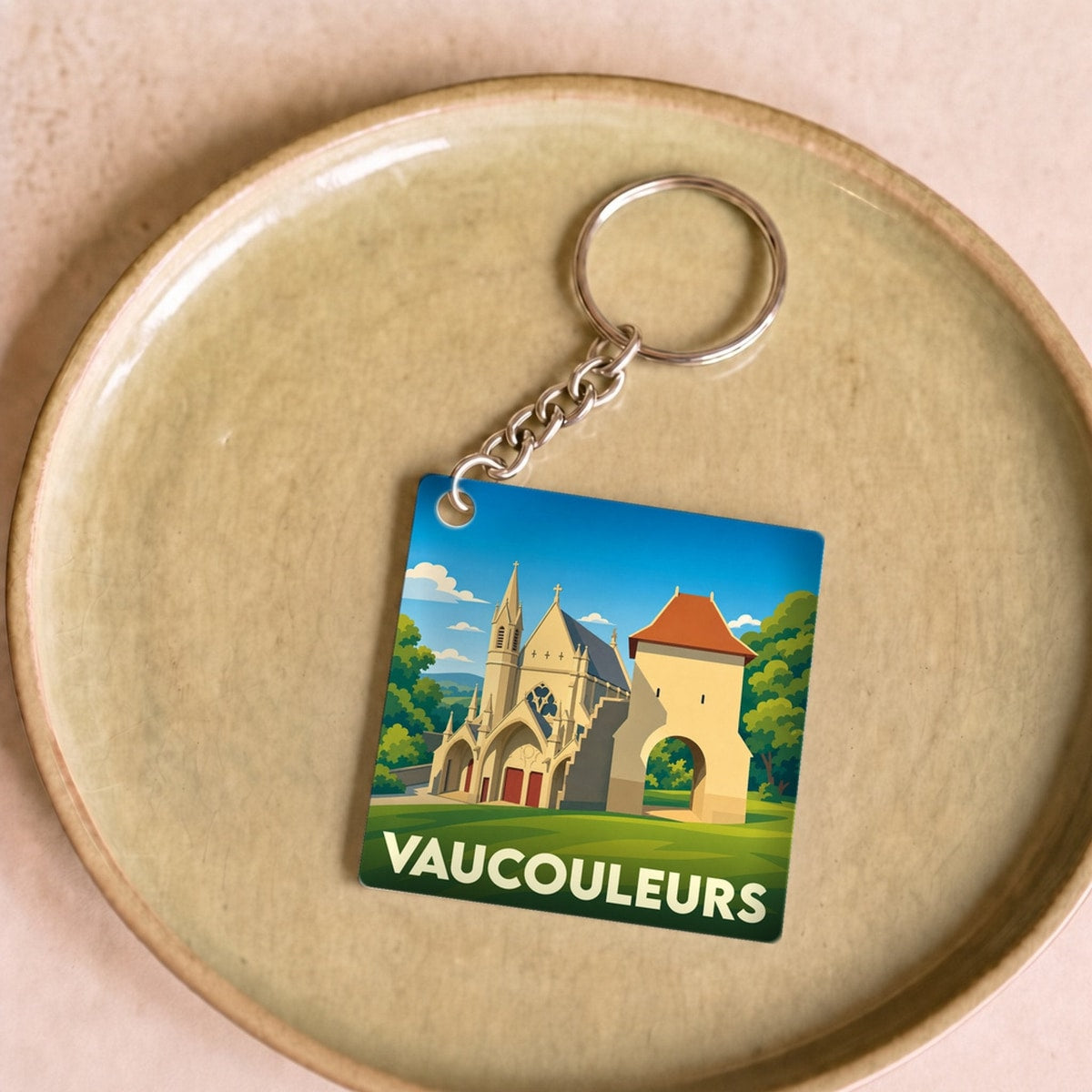 Porte-clés souvenir de la ville de Vaucouleurs avec une illustration stylisée de son patrimoine.