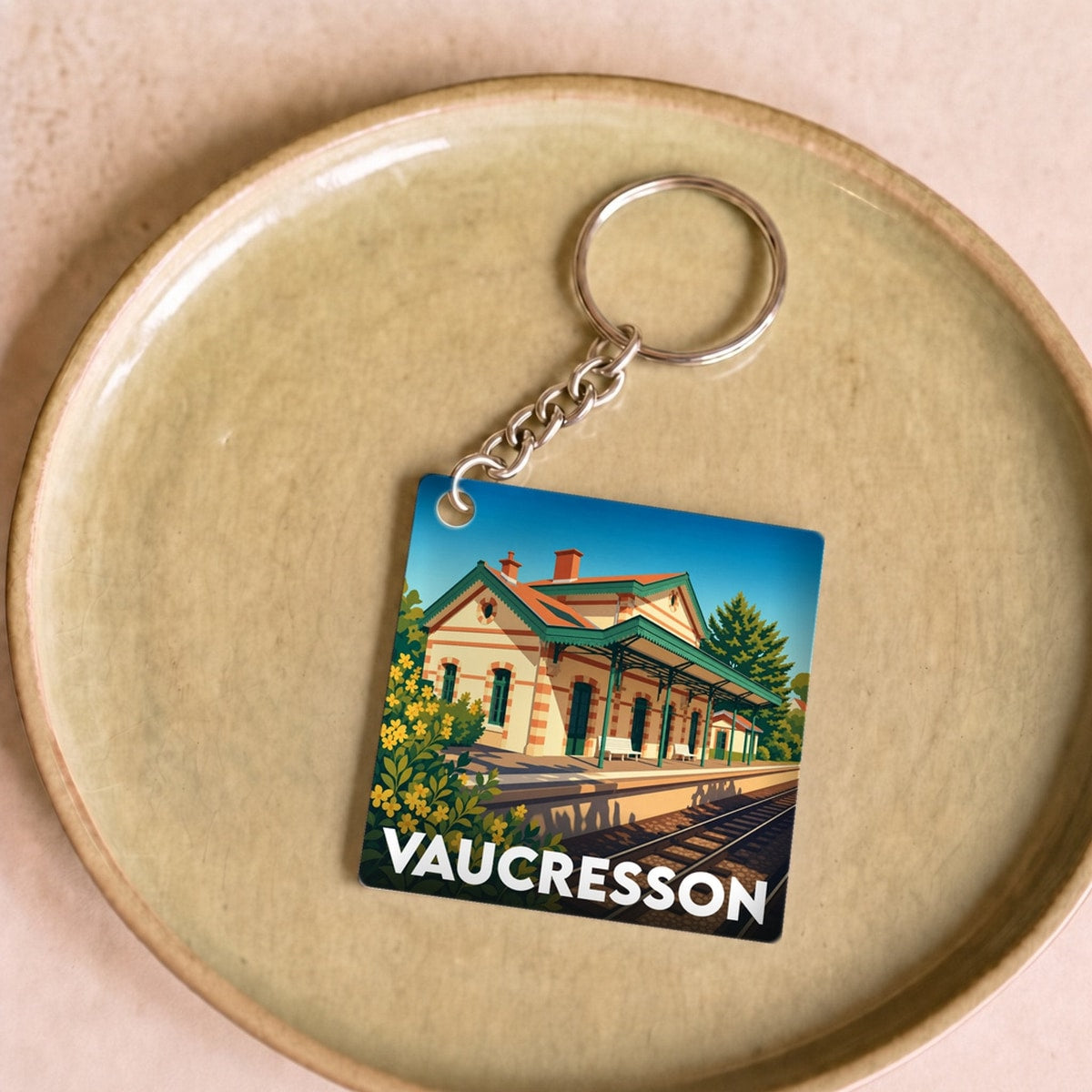 Porte-clés souvenir de la ville de Vaucresson avec une illustration stylisée de sa gare.
