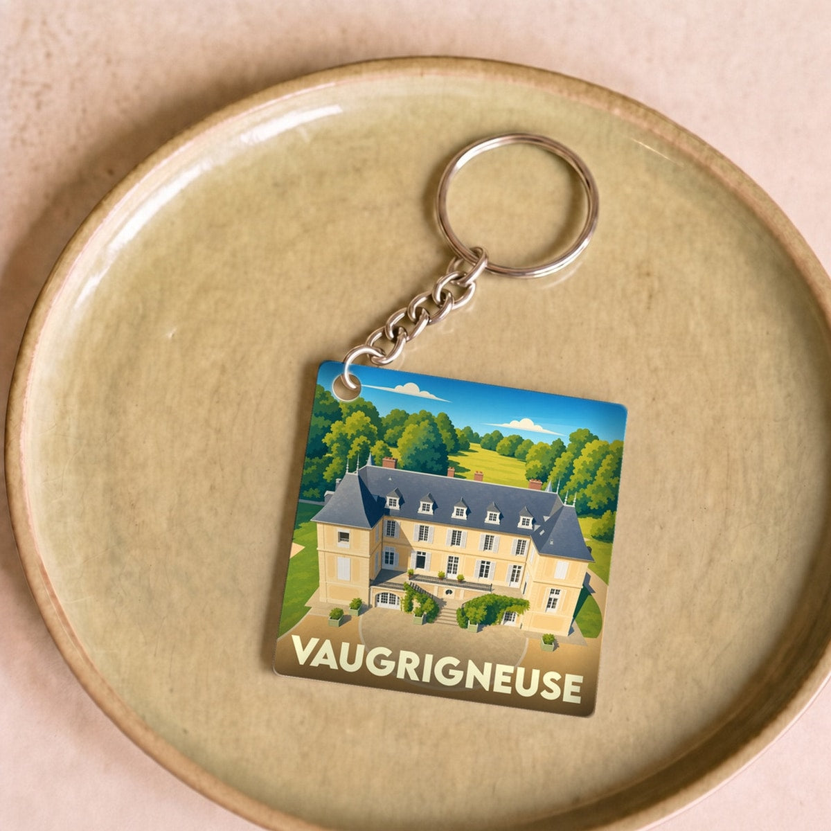 Porte-clés souvenir de la ville de Vaugrigneuse avec une illustration stylisée de son château.