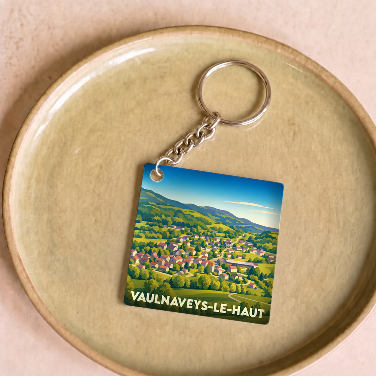 Porte-clés souvenir de la ville de Vaulnaveys-le-Haut avec une illustration stylisée.