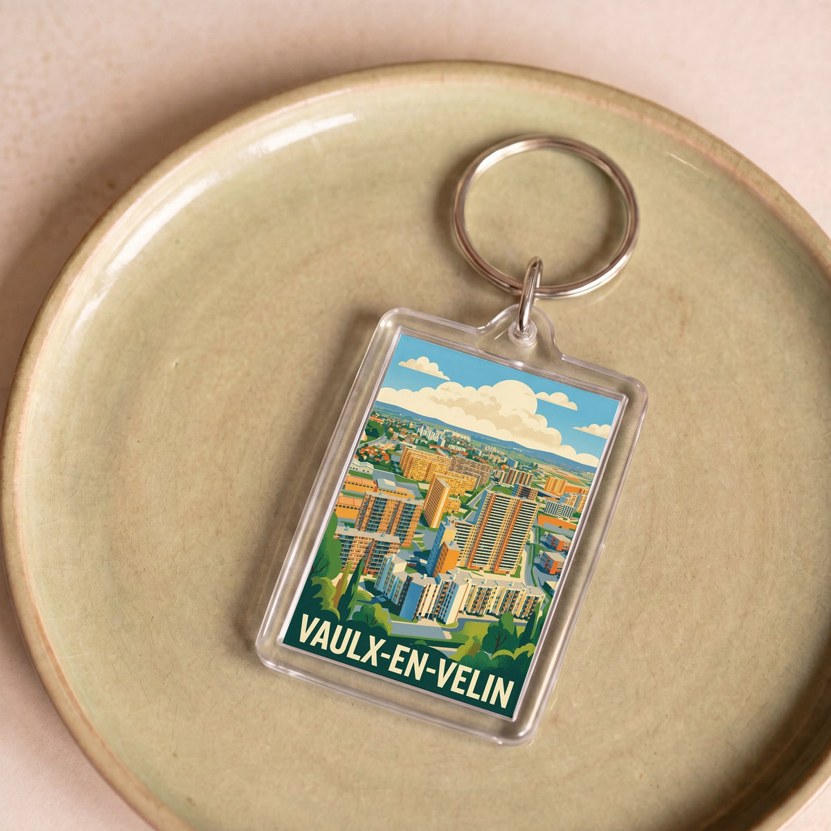 Porte-clés souvenir de la ville de Vaulx-en-Velin avec une illustration stylisée.