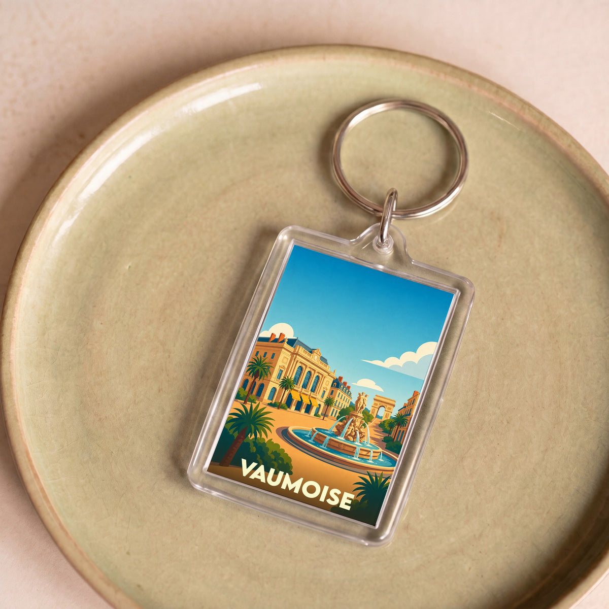 Porte-clés souvenir de la ville de Vaumoise avec une illustration stylisée.