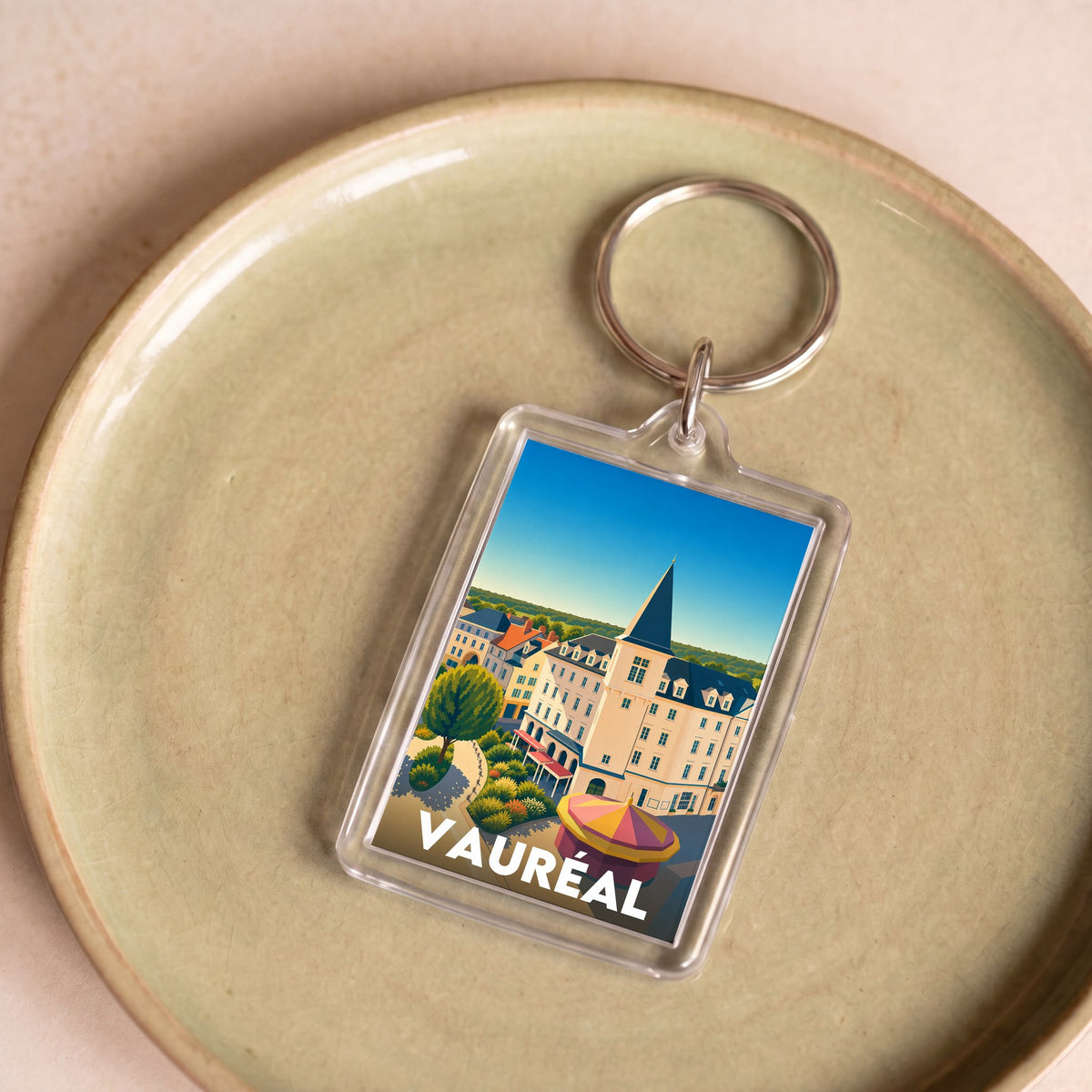 Porte-clés souvenir de la ville de Vauréal avec une illustration stylisée.