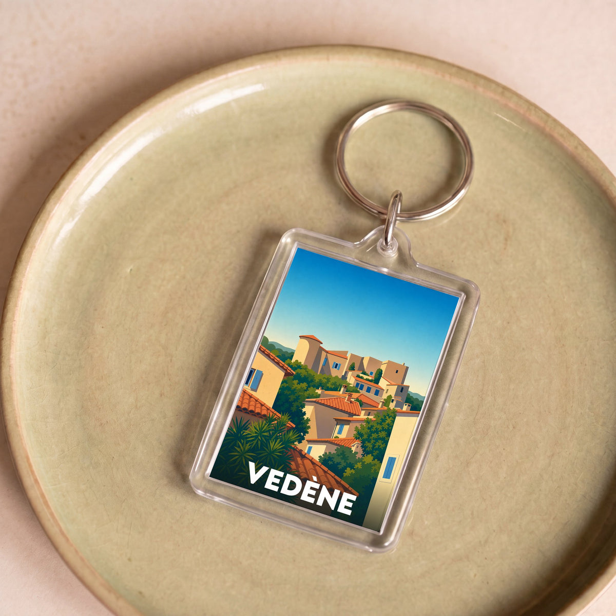 Porte-clés souvenir de la ville de Vedène avec une illustration stylisée de son architecture provençale.
