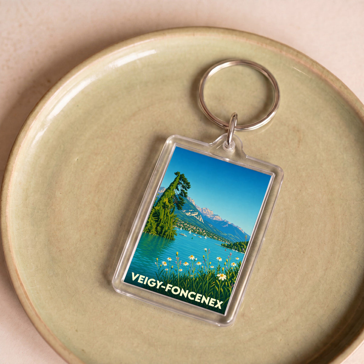 Porte-clés souvenir de la ville de Veigy-Foncenex avec une illustration stylisée de bord de lac.