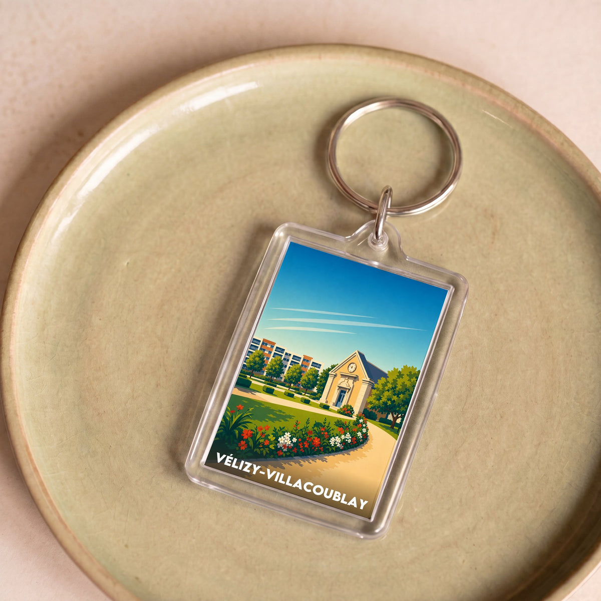 Porte-clés souvenir de la ville de Vélizy-Villacoublay avec une illustration colorée et stylisée.