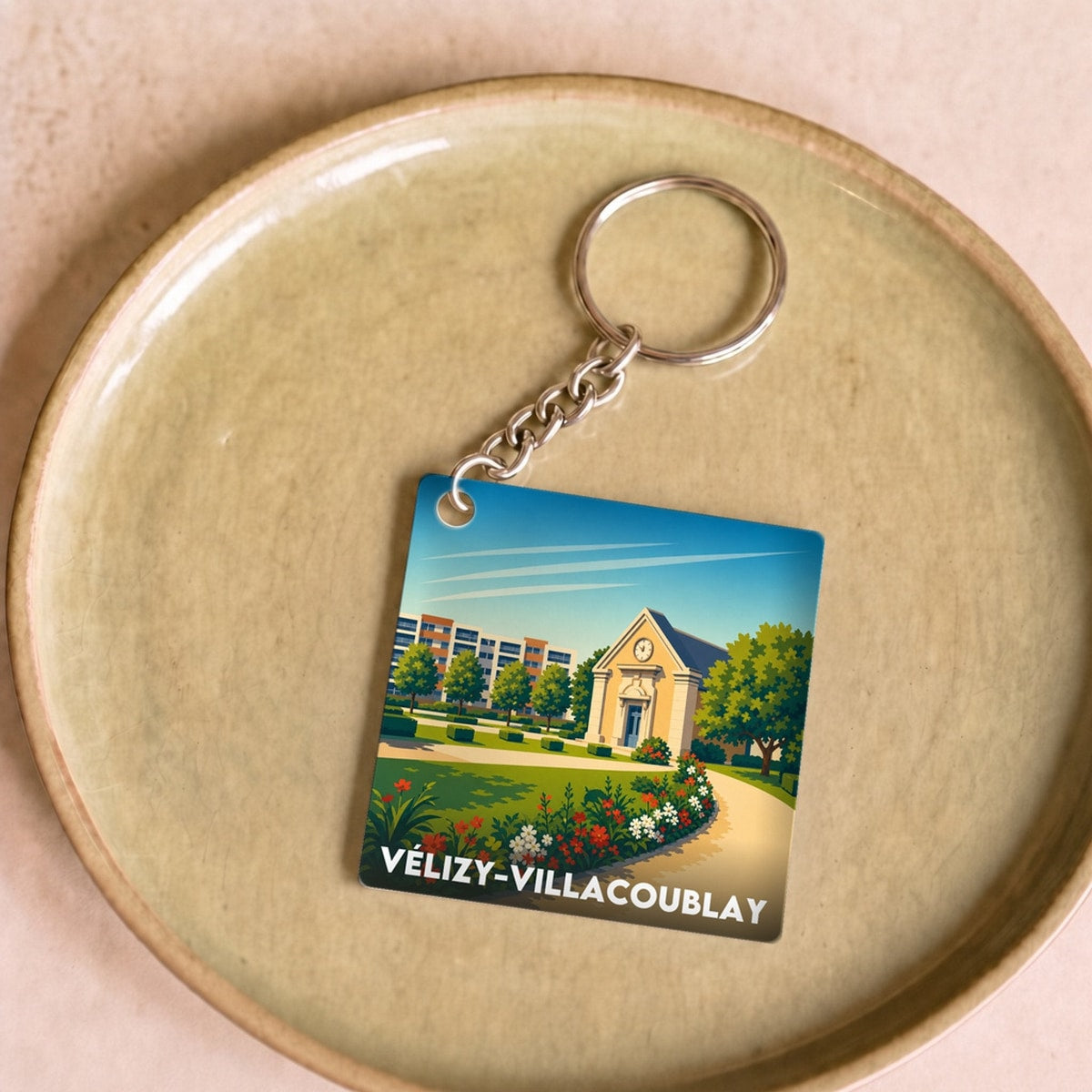 Porte-clés souvenir de la ville de Vélizy-Villacoublay avec une illustration colorée et stylisée.