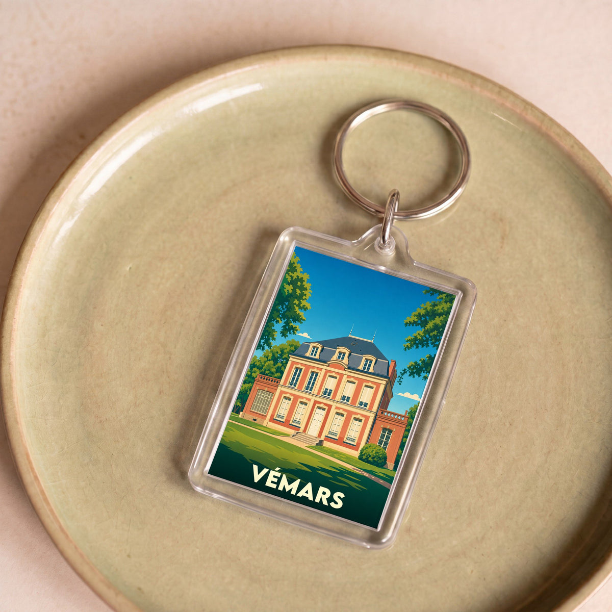 Porte-clés souvenir de la ville de Vémars avec une illustration stylisée d'un château.