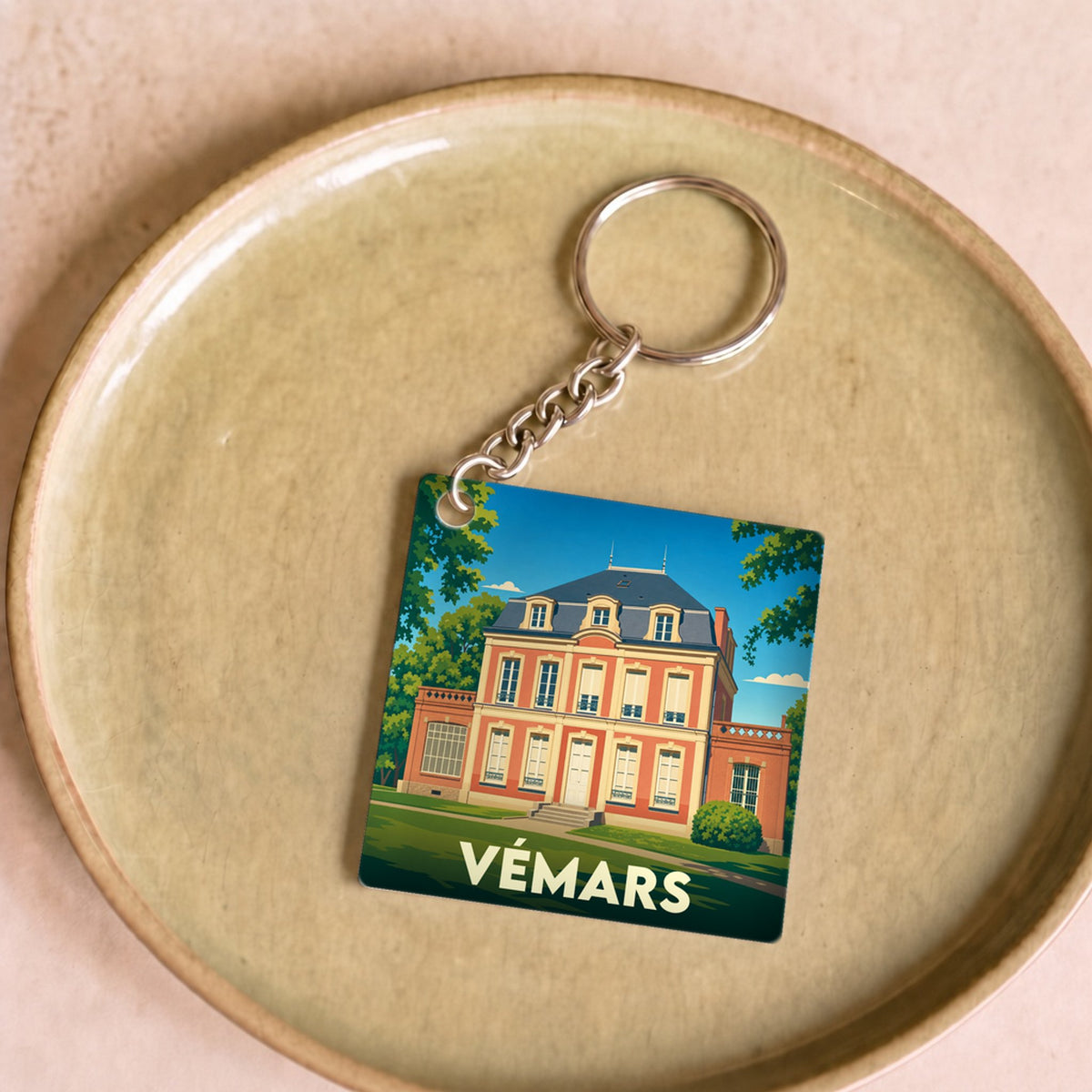Porte-clés souvenir de la ville de Vémars avec une illustration stylisée d'un château.
