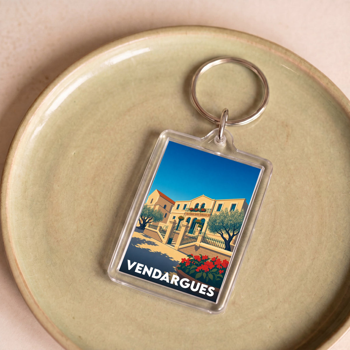 Porte-clés souvenir de la ville de Vendargues avec une illustration stylisée.