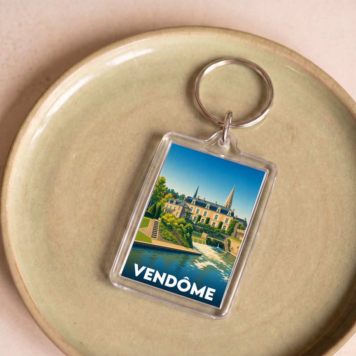 Porte-clés souvenir de la ville de Vendôme avec une illustration stylisée.