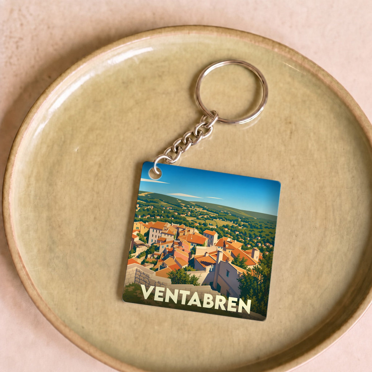 Porte-clés souvenir de la ville de Ventabren avec une illustration stylisée.