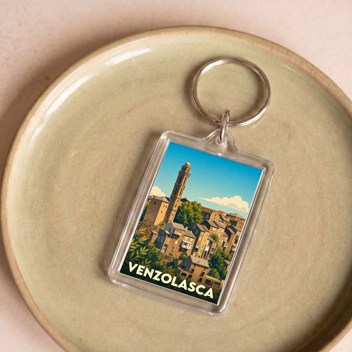 Porte-clés souvenir de la ville de Venzolasca avec une illustration stylisée.