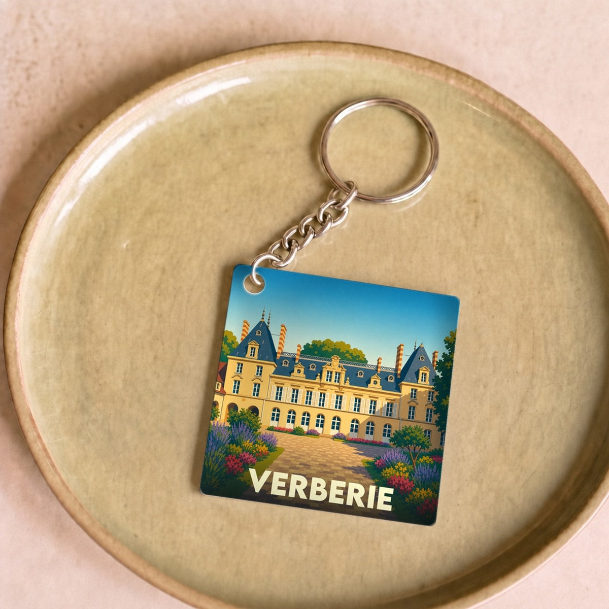 Porte-clés souvenir de la ville de Verberie avec une illustration stylisée de son patrimoine.