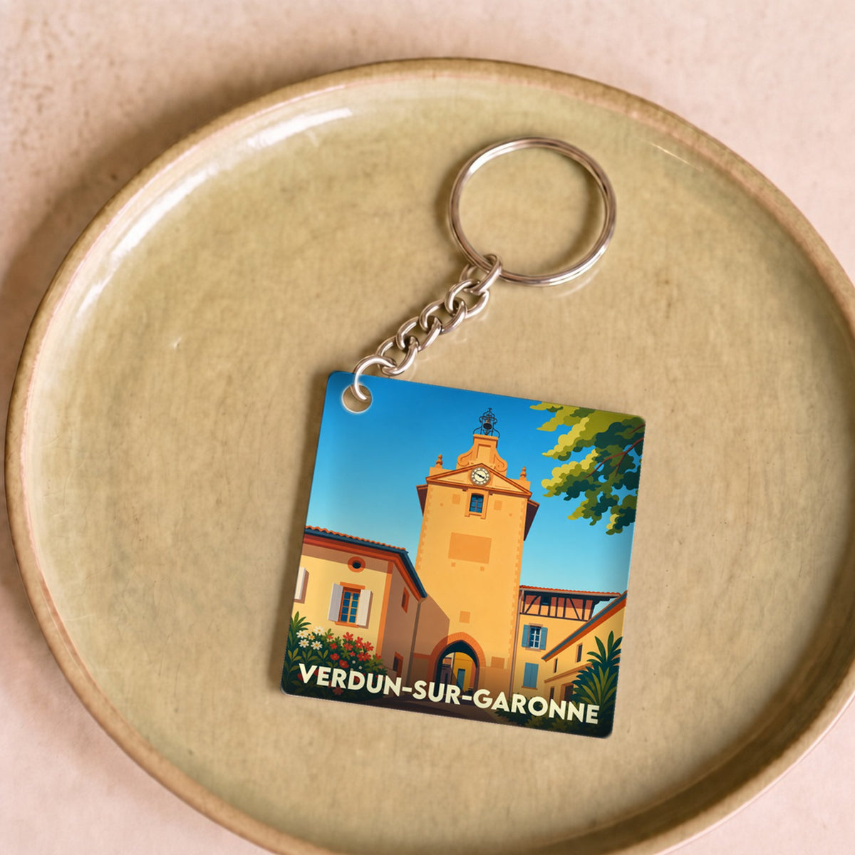 Porte-clés souvenir de la ville de Verdun-sur-Garonne avec une illustration stylisée de sa tour de l'horloge.