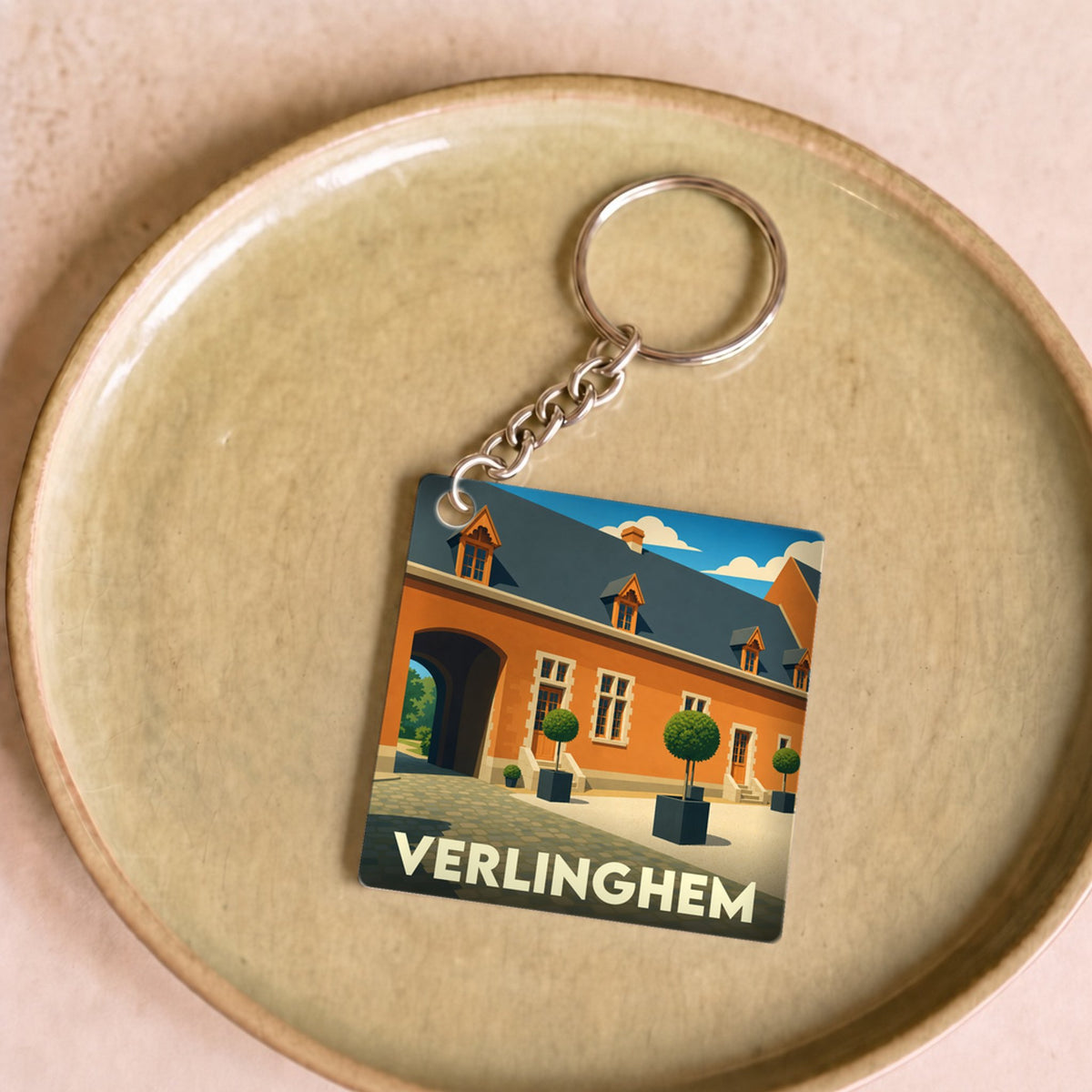 Porte-clés souvenir de la ville de Verlinghem avec une illustration stylisée.