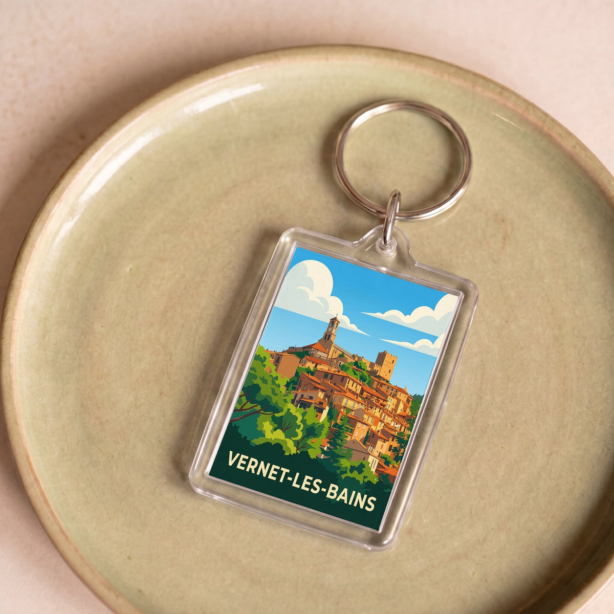 Porte-clés souvenir de la ville de Vernet-les-Bains avec une illustration graphique colorée.