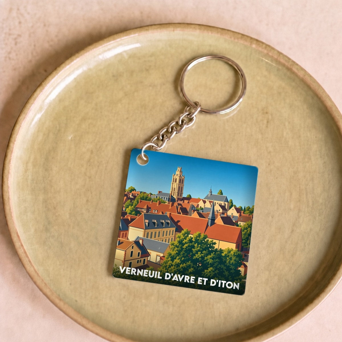 Porte-clés souvenir de la ville de Verneuil d'Avre et d'Iton avec une illustration stylisée.
