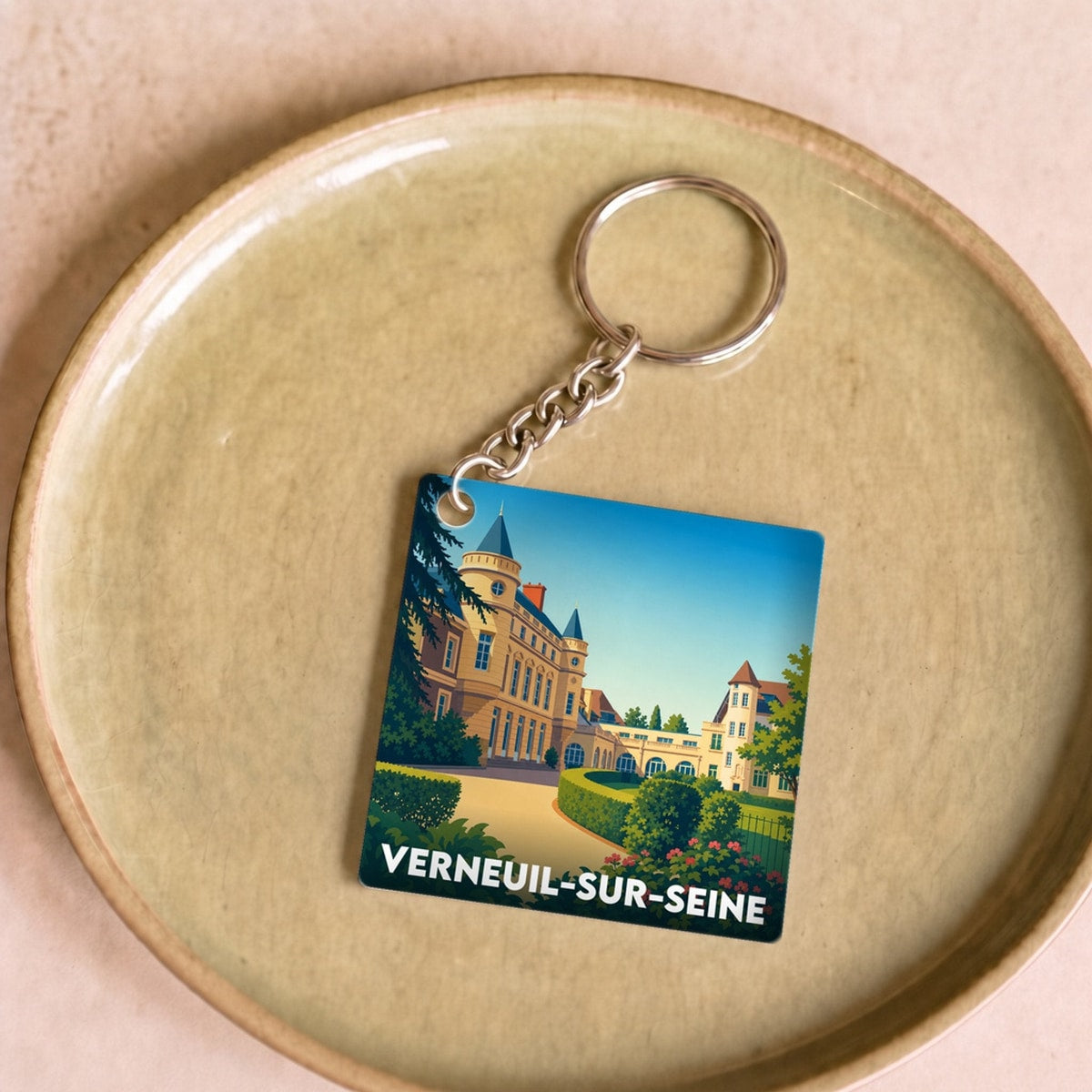 Porte-clés souvenir de la ville de Verneuil-sur-Seine avec une illustration stylisée.
