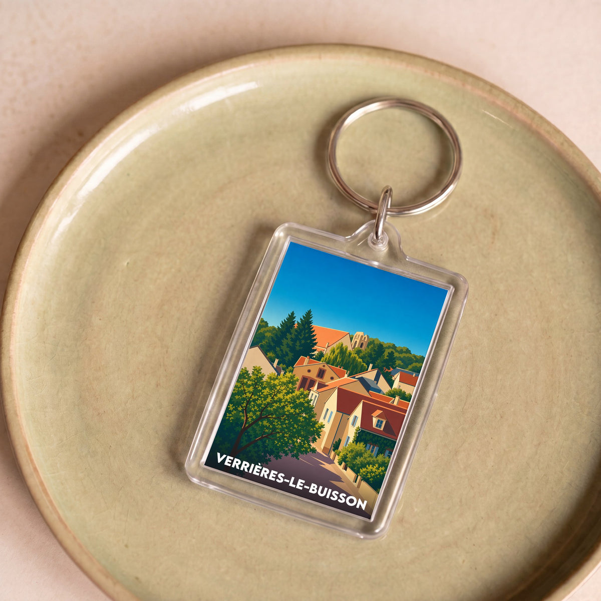 Porte-clés souvenir de la ville de Verrières-le-Buisson avec une illustration stylisée de ses maisons.