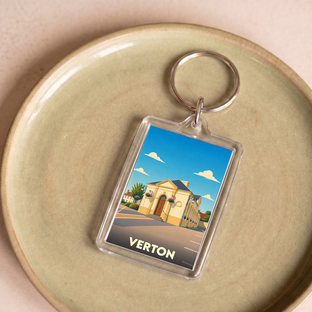Porte-clés souvenir de la ville de Verton avec une illustration stylisée.