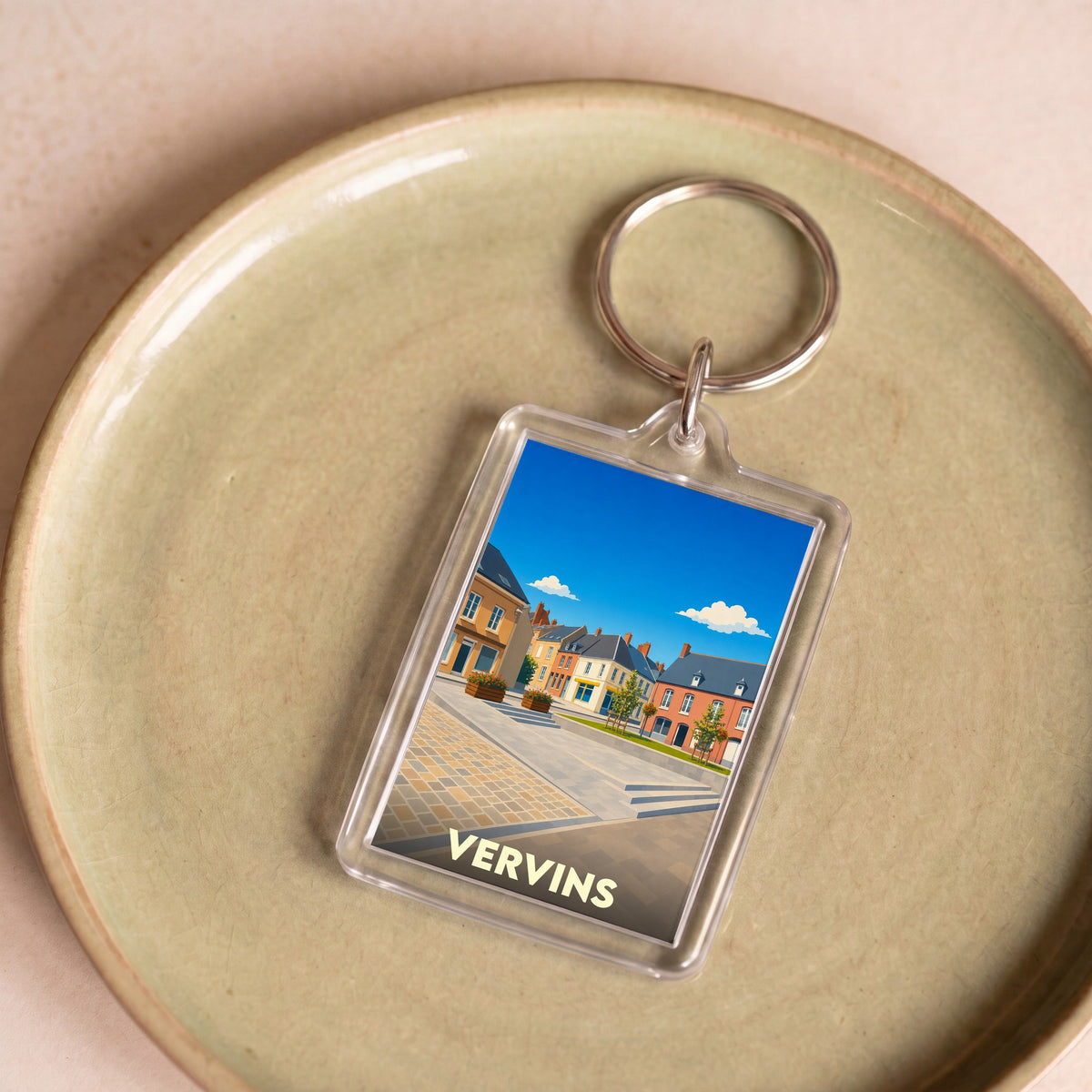 Porte-clés souvenir de la ville de Vervins avec une illustration stylisée.