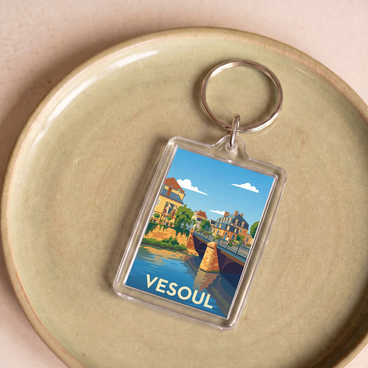 Porte-clés souvenir de la ville de Vesoul avec une illustration stylisée.