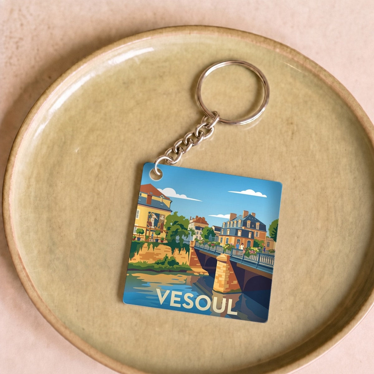 Porte-clés souvenir de la ville de Vesoul avec une illustration stylisée.