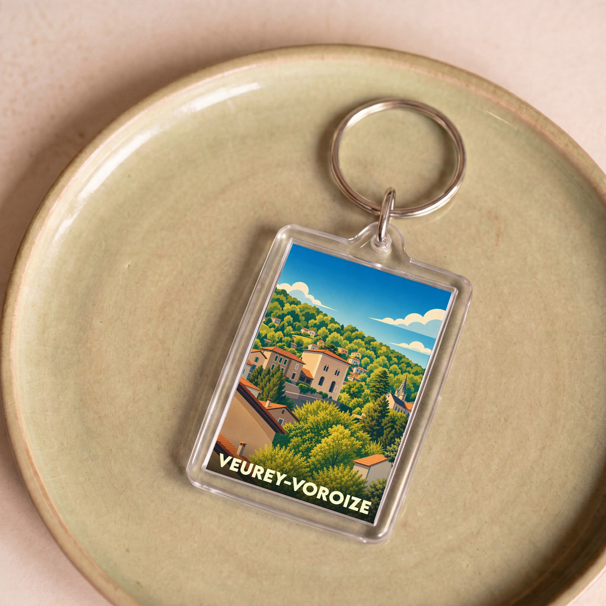 Porte-clés souvenir de la ville de Veurey-Voroize avec une illustration stylisée.