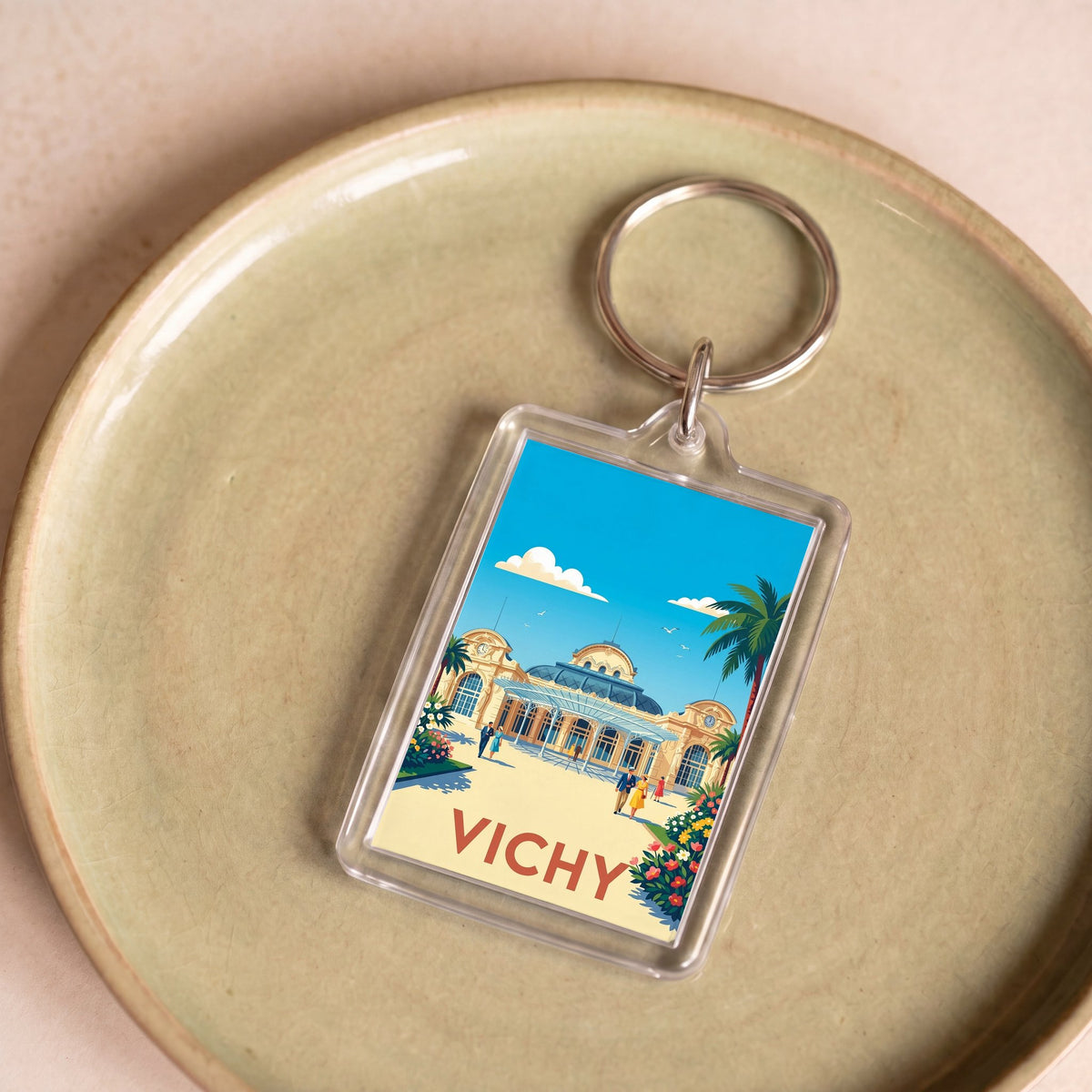 Porte-clés souvenir de la ville de Vichy avec une illustration stylisée.