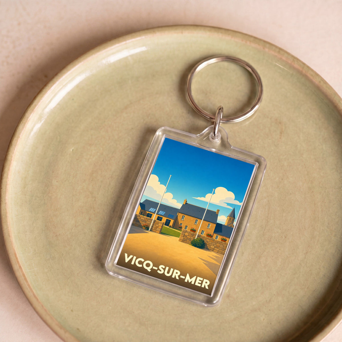 Porte-clés souvenir de la ville de Vicq-sur-Mer avec une illustration stylisée.