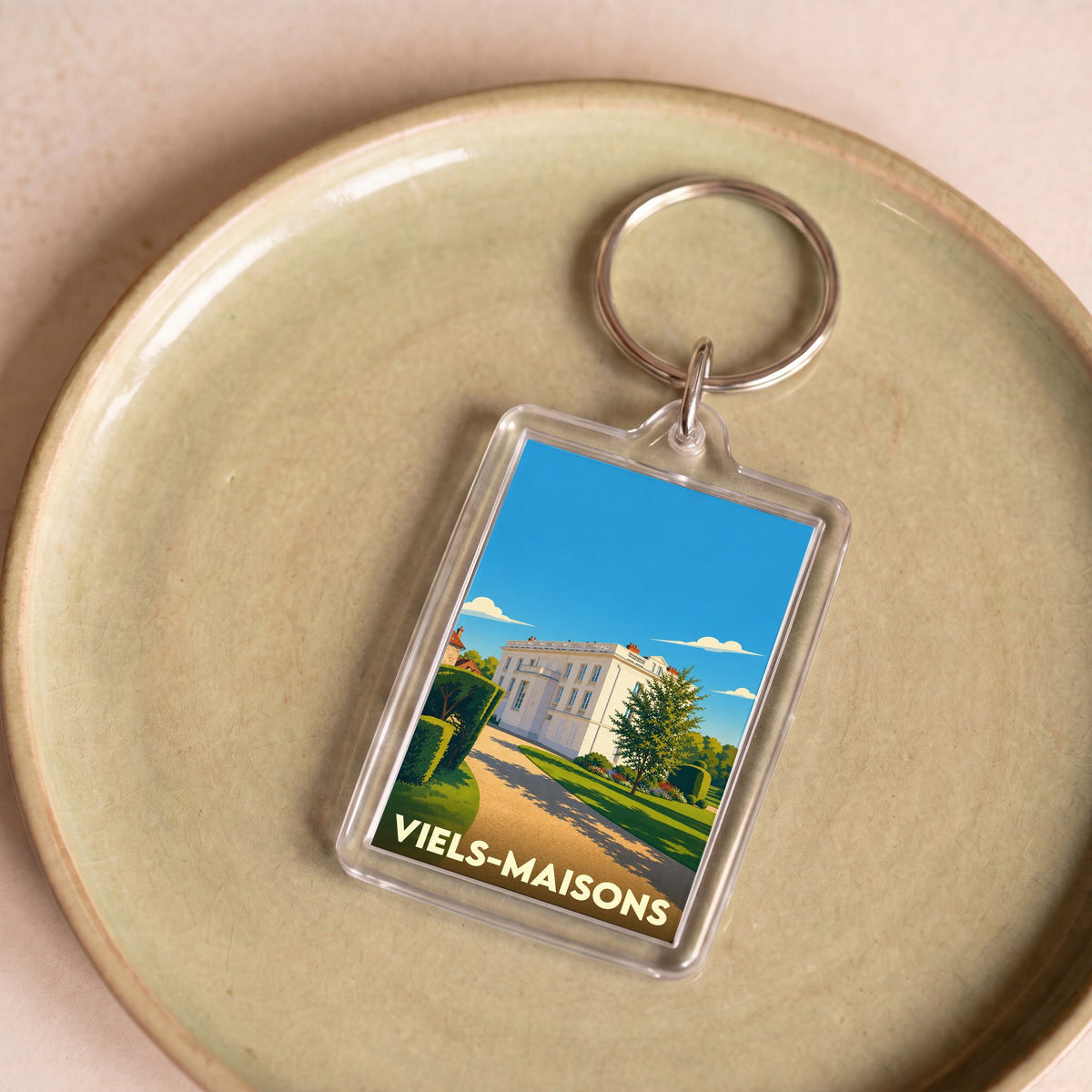 Porte-clés souvenir de la ville de Viels-Maisons avec une illustration stylisée d'un château.