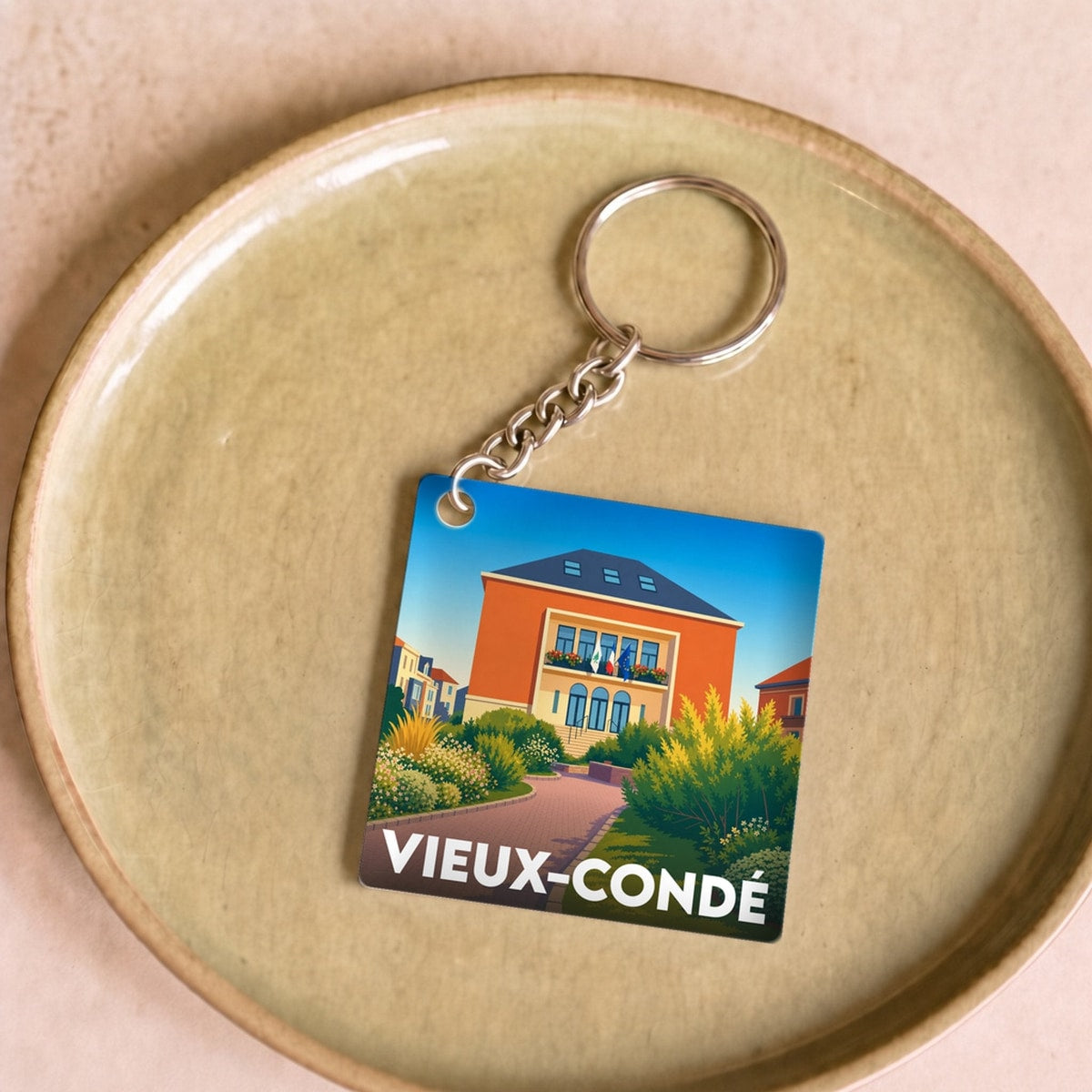 Porte-clés souvenir de la ville de Vieux-Condé avec une illustration stylisée.