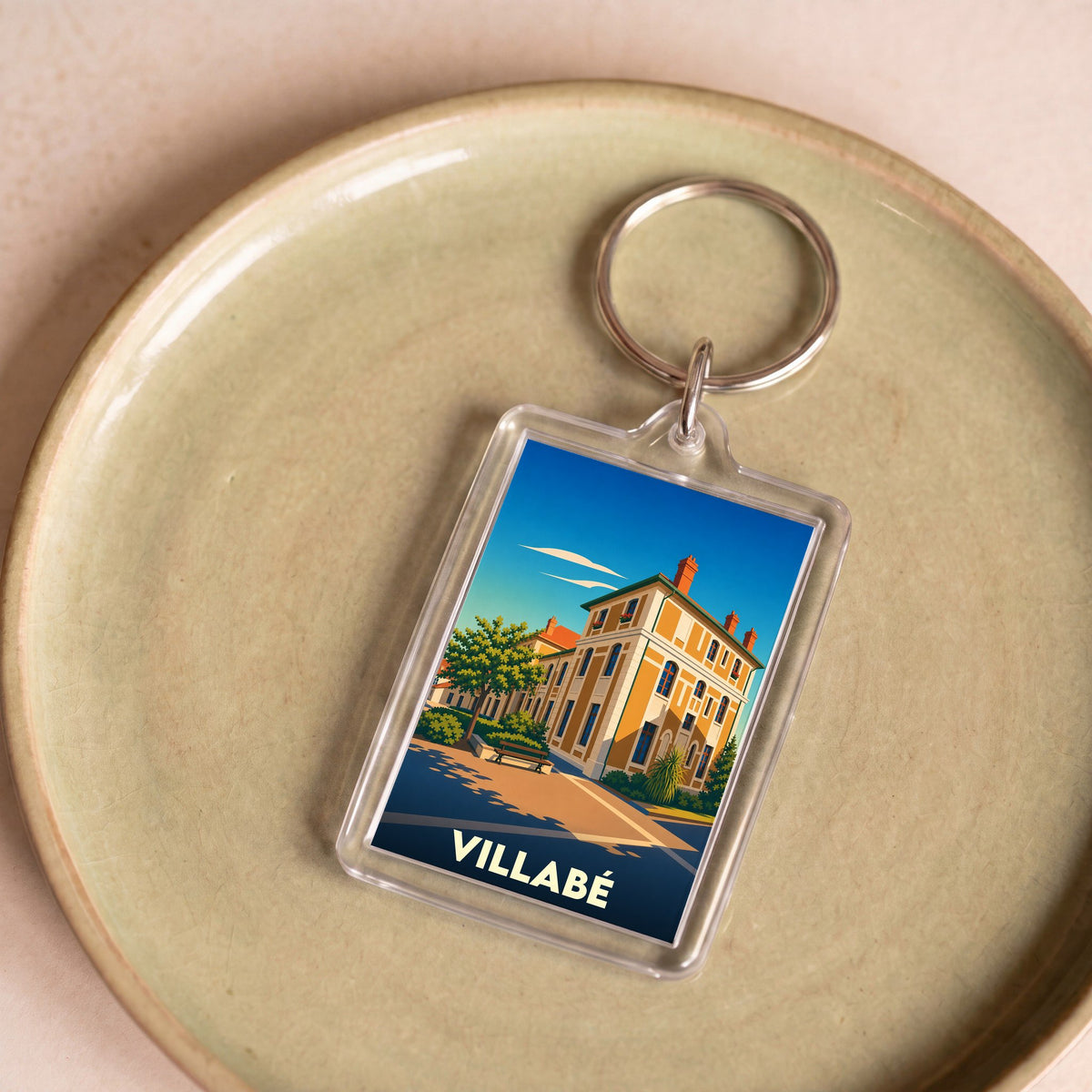Porte-clés souvenir de la ville de Villabé avec une illustration stylisée.