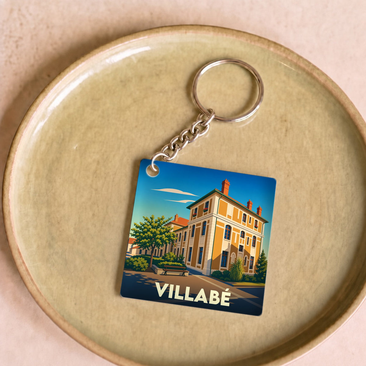 Porte-clés souvenir de la ville de Villabé avec une illustration stylisée.