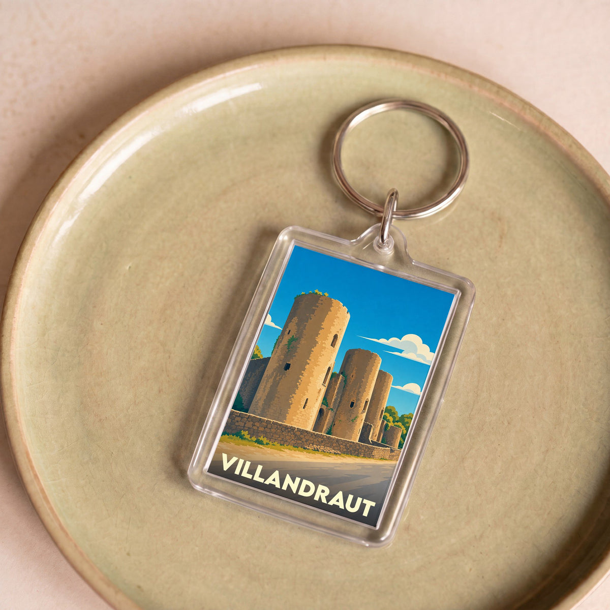 Porte-clés souvenir de la ville de Villandraut avec une illustration stylisée de son château.