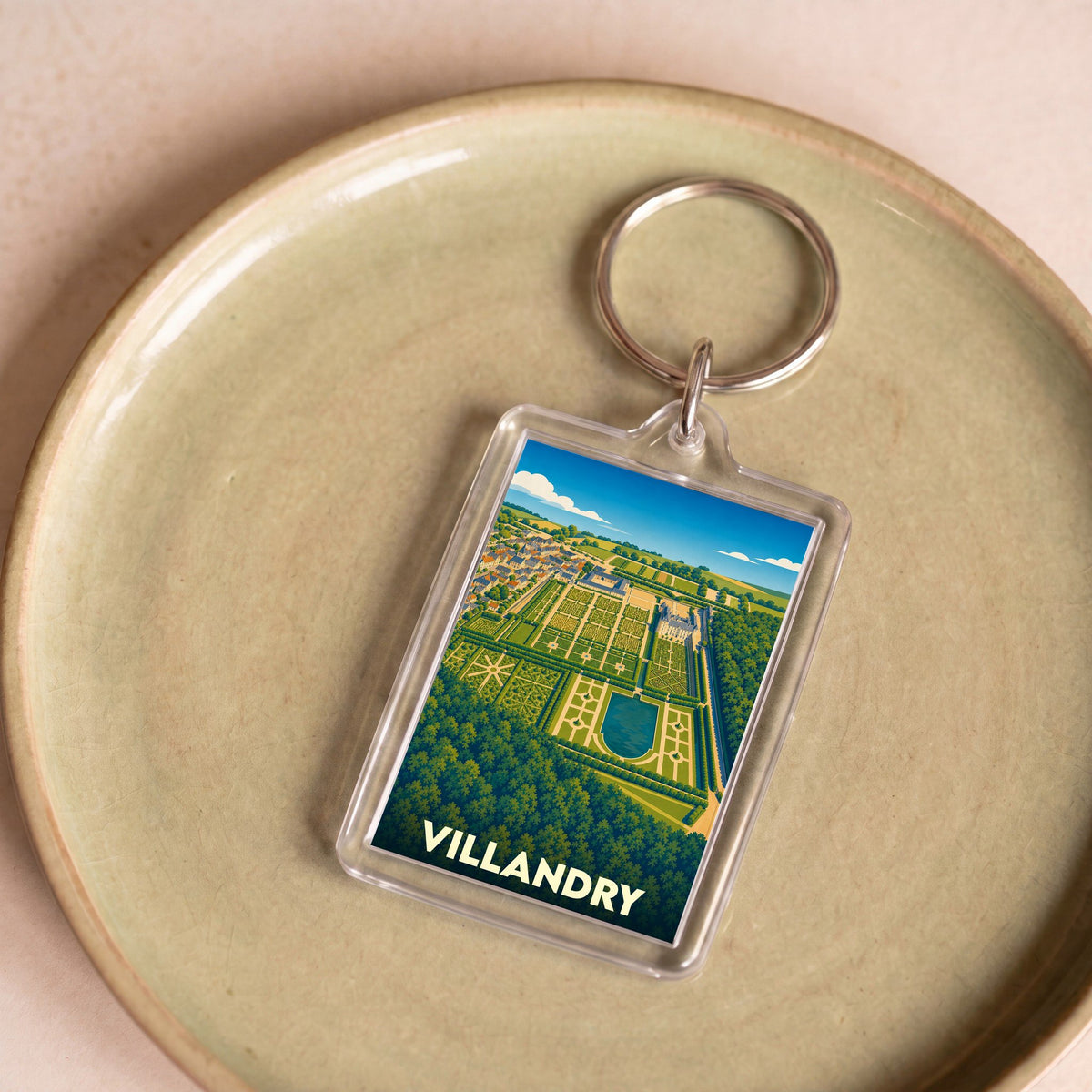 Porte-clés souvenir de Villandry orné d'une illustration stylisée de son château et de ses jardins renommés.