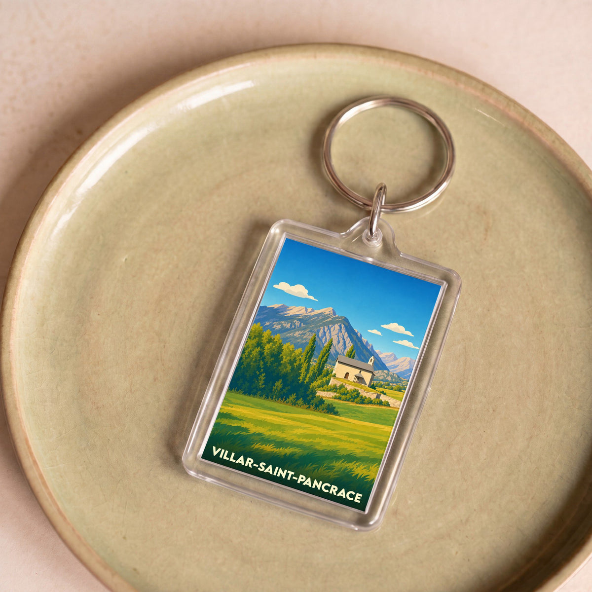 Porte-clés souvenir de la ville de Villar-Saint-Pancrace avec une illustration stylisée d'un paysage montagneux.