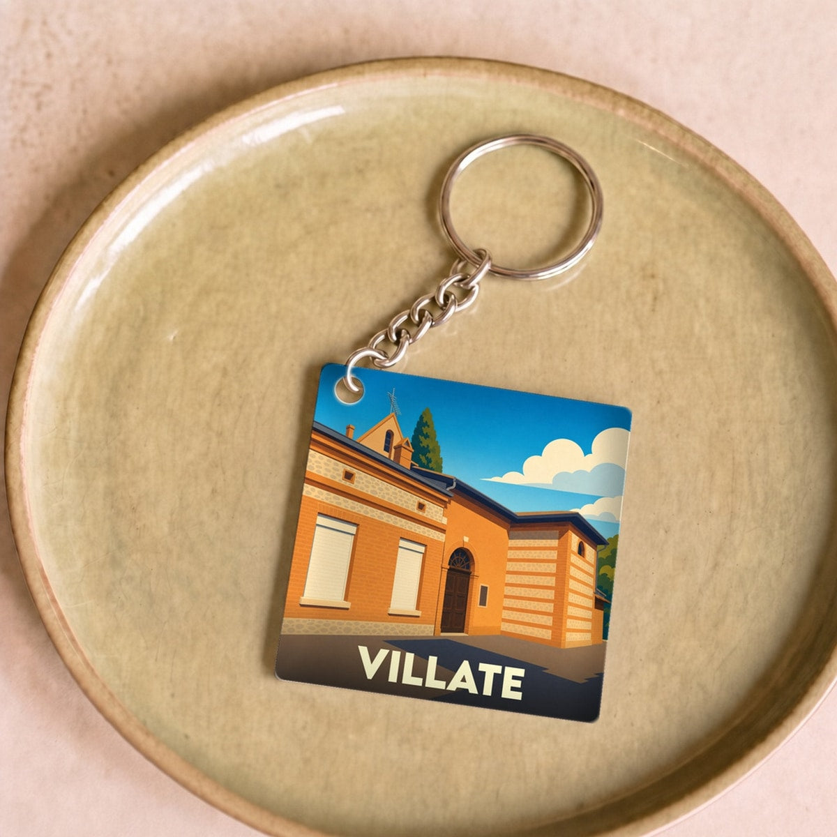 Porte-clés souvenir de la ville de Villate avec une illustration stylisée.