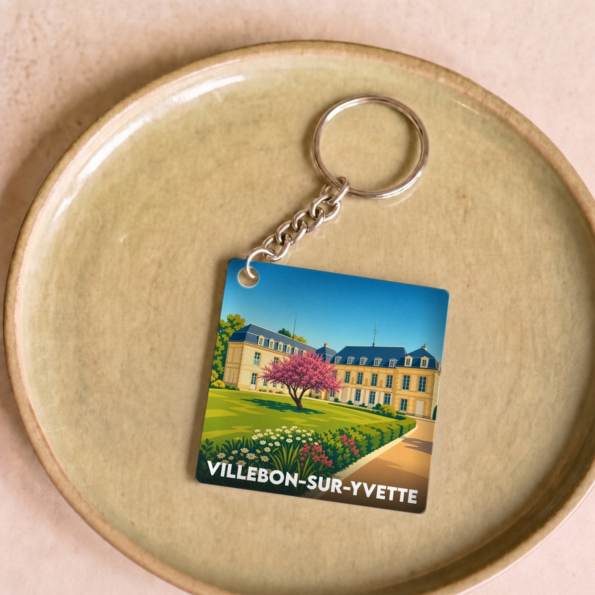 Porte-clés souvenir de la ville de Villebon-sur-Yvette avec une illustration stylisée d'un château.