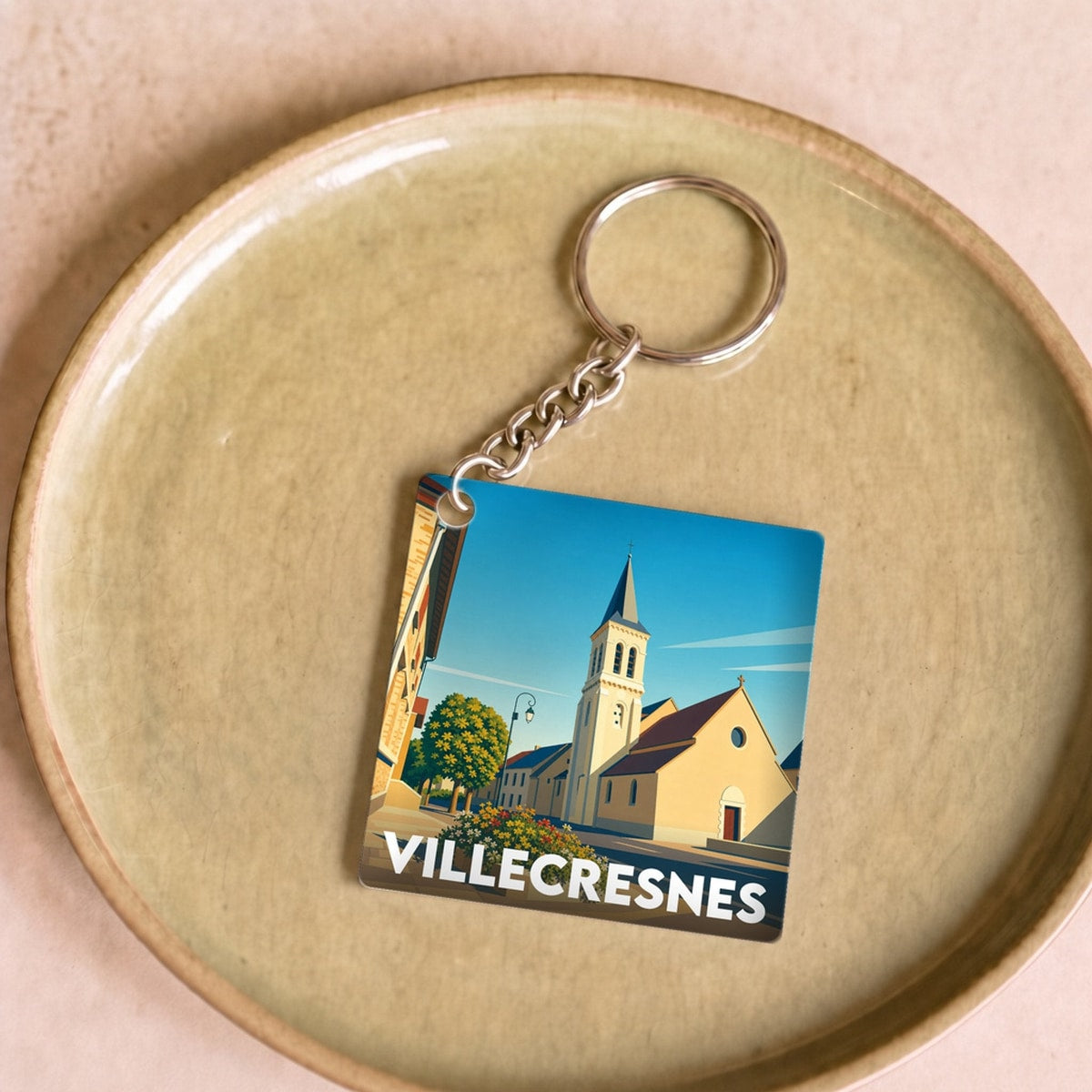 Porte-clés souvenir de la ville de Villecresnes avec une illustration stylisée.