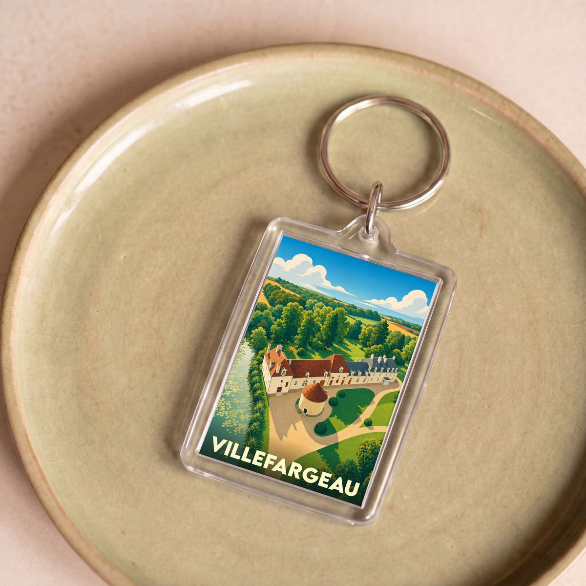 Porte-clés souvenir de la ville de Villefargeau avec une illustration stylisée.