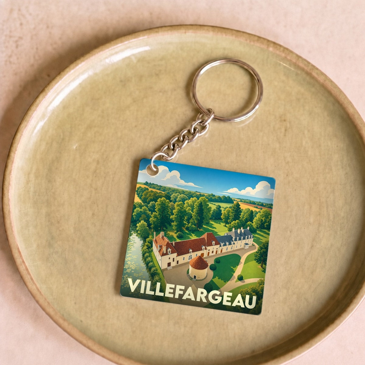 Porte-clés souvenir de la ville de Villefargeau avec une illustration stylisée.