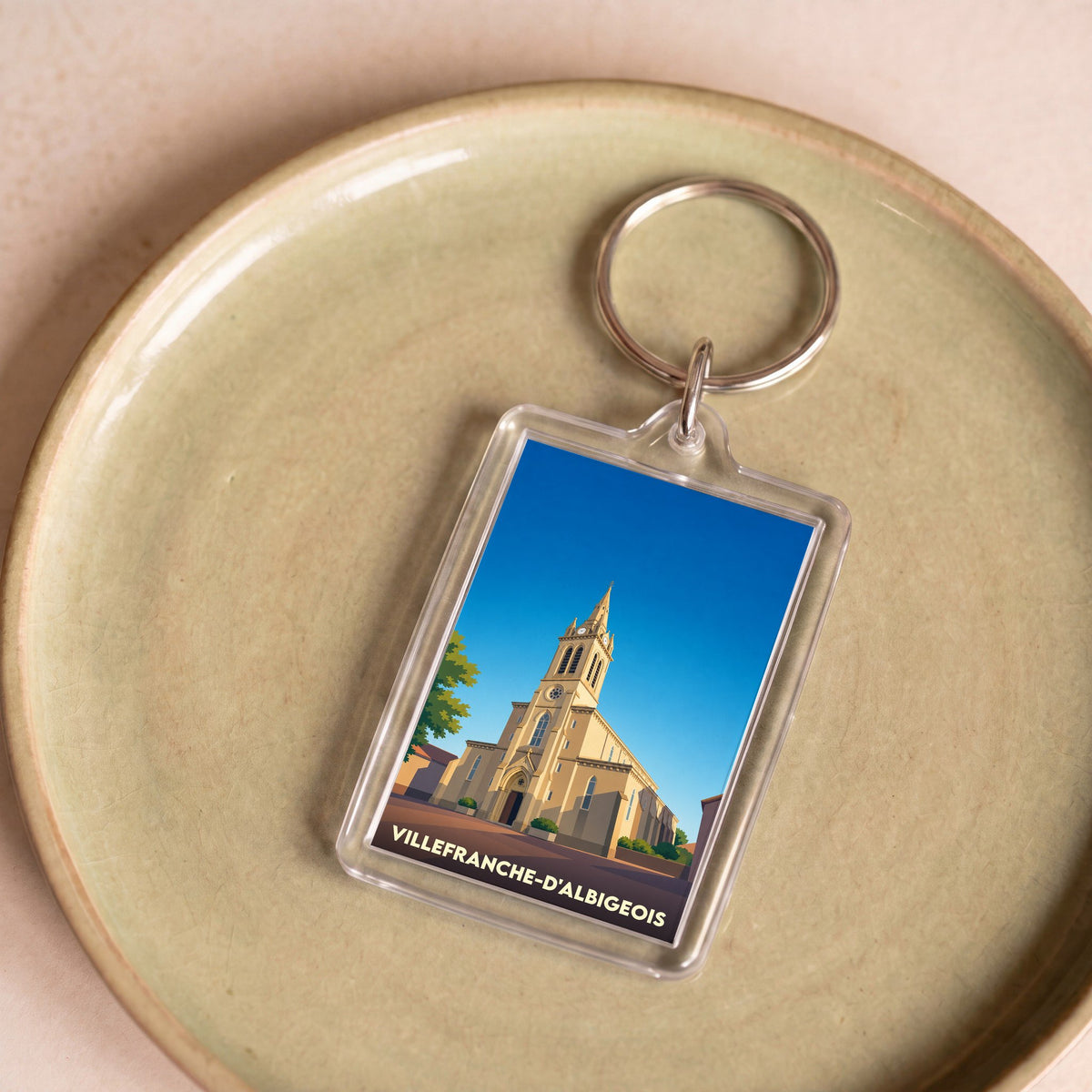 Porte-clés souvenir de la ville de Villefranche-d'Albigeois avec une illustration stylisée de son église.