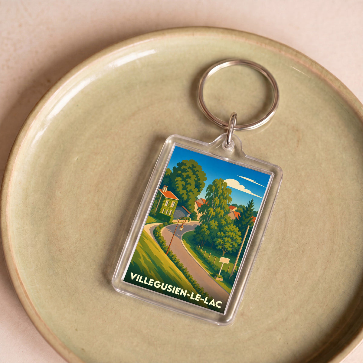 Porte-clés souvenir de la ville de Villegusien-le-Lac avec une illustration stylisée.