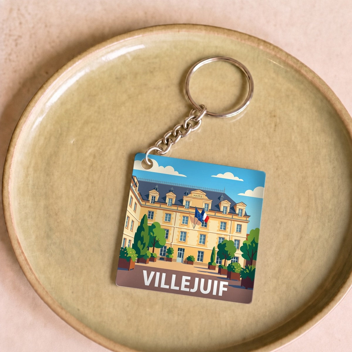 Porte-clés souvenir de la ville de Villejuif avec une illustration stylisée.