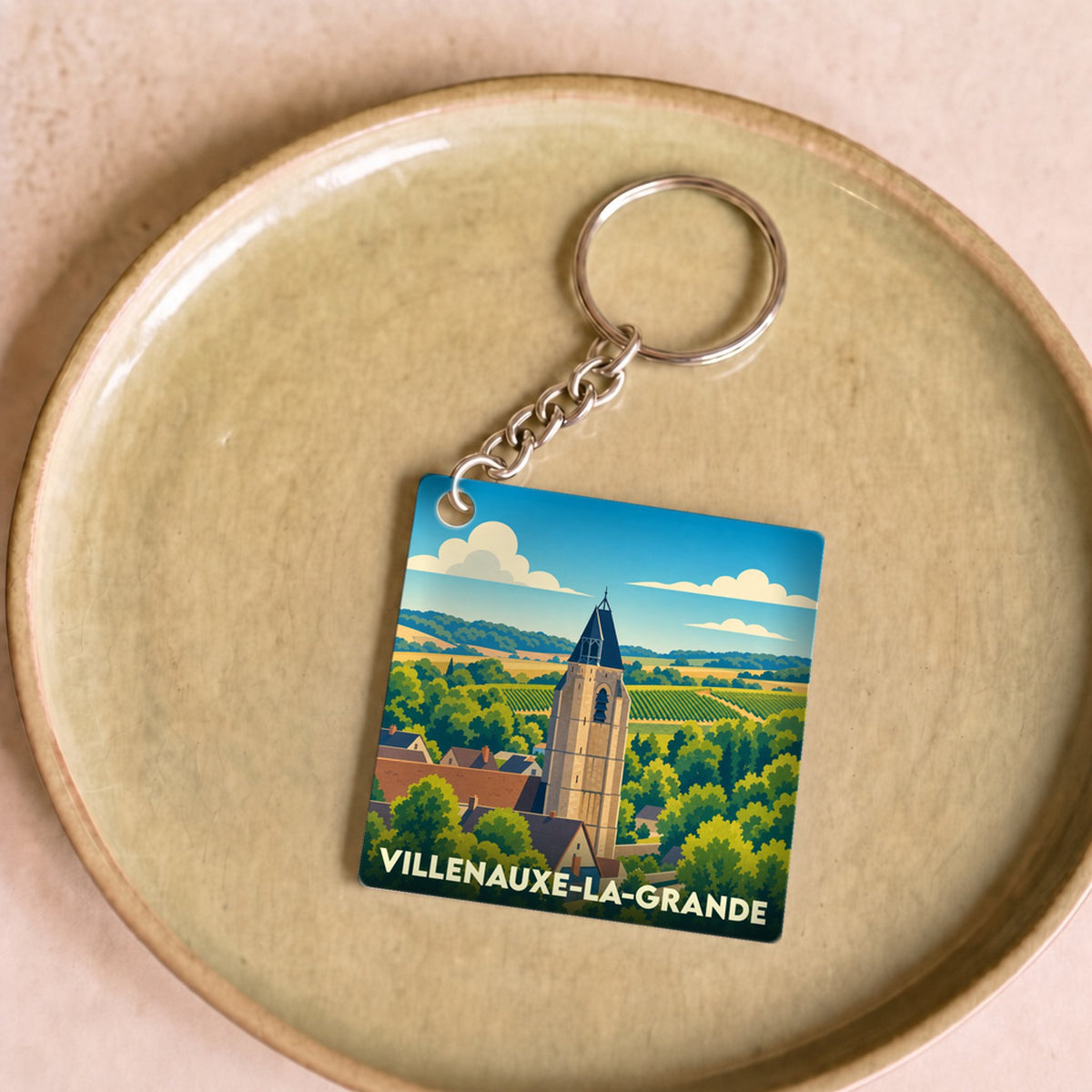 Porte-clés souvenir de la ville de Villenauxe-la-Grande avec une illustration stylisée.
