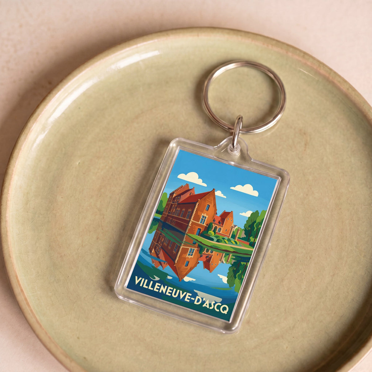 Porte-clés souvenir de la ville de Villeneuve-d'Ascq avec une illustration stylisée.