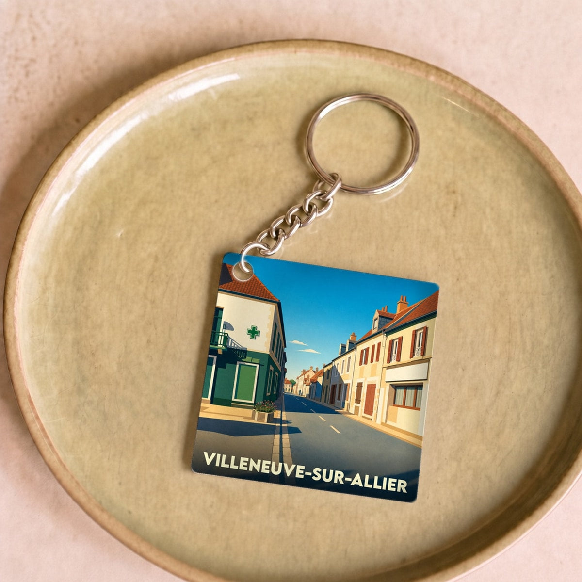 Porte-clés souvenir de la ville de Villeneuve-sur-Allier avec une illustration stylisée.